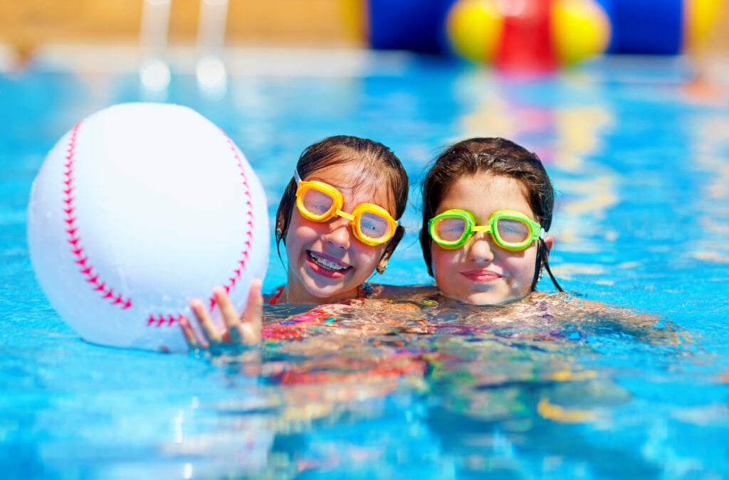 teenage friends with braces in summer pool